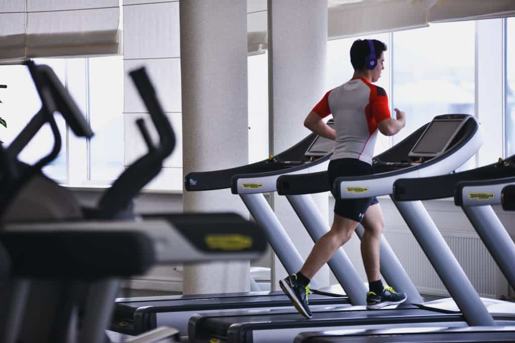 man running on a treadmill in a gym