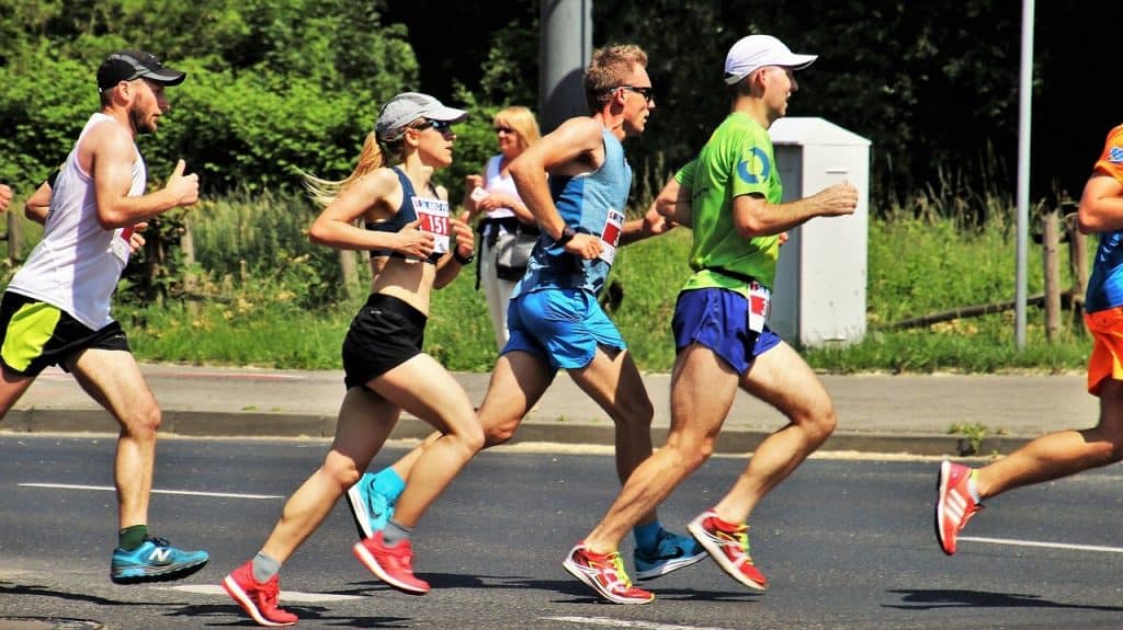 side shot from a marathon, men and women running : Marathon Runner's Body