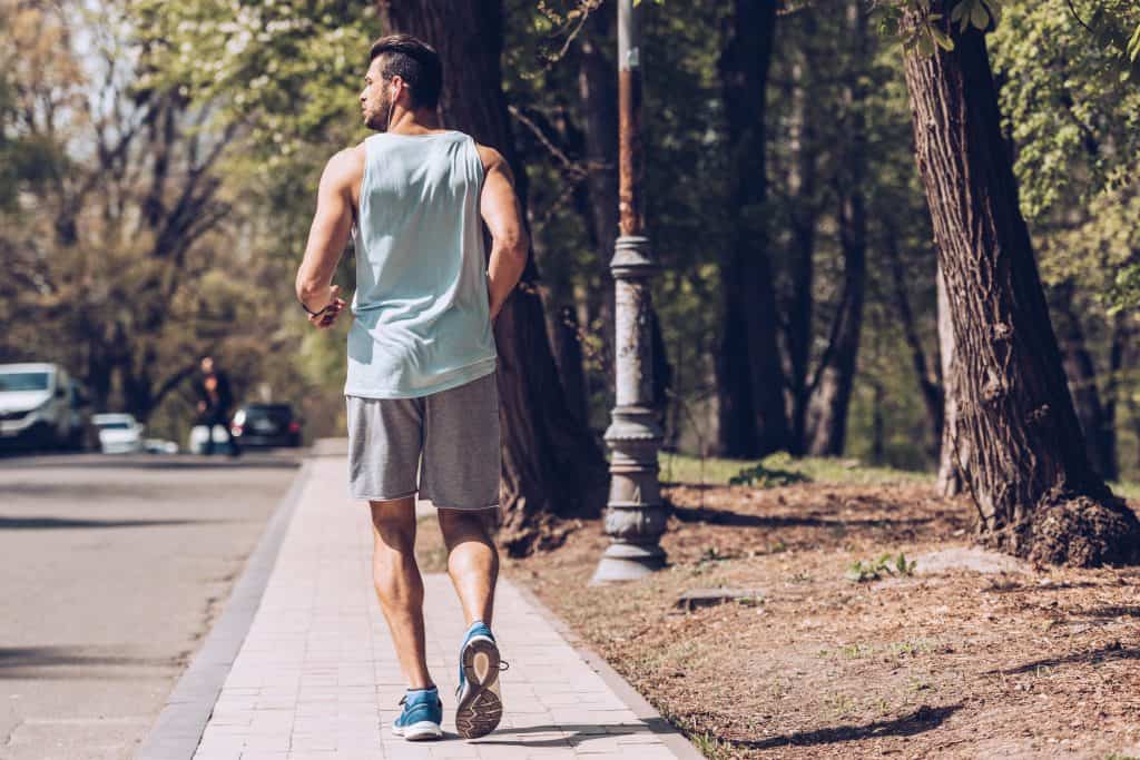 back of a man jogging outdoors