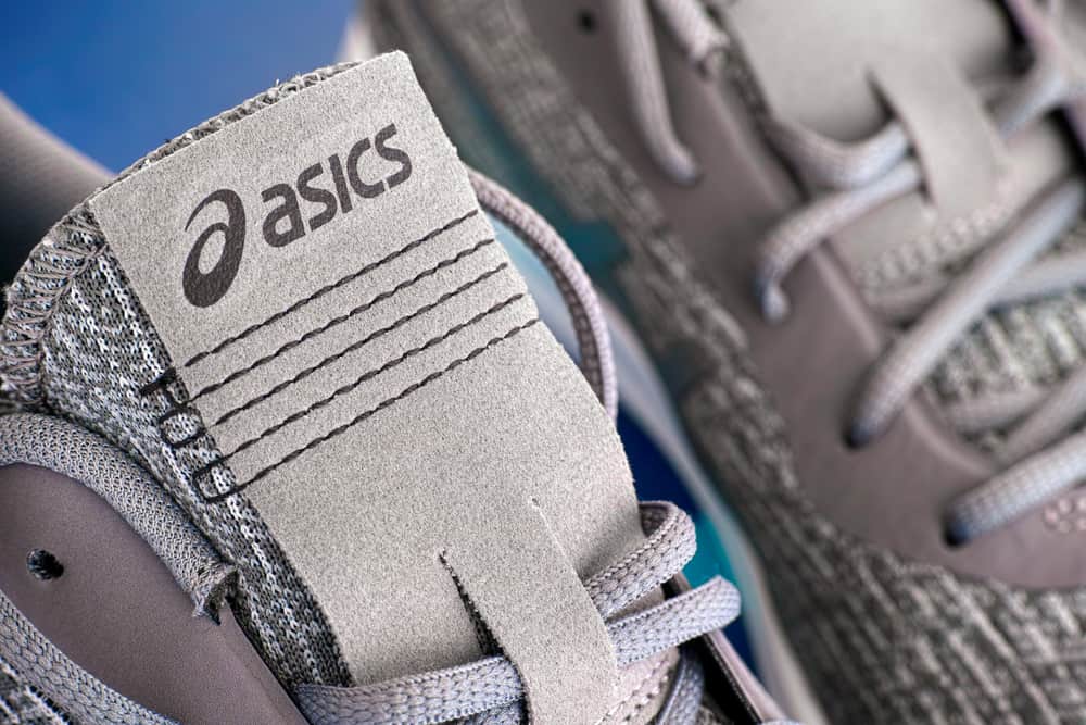 Close-up of new gray Asics running shoes. Studio shot.