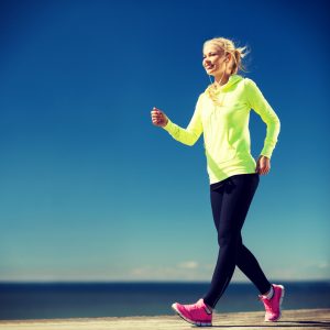 Does Walking Tone Your Legs: fitness and lifestyle concept - woman walking outdoors