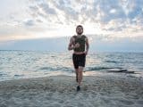 Young bearded athlete training outdoor with weighted vest