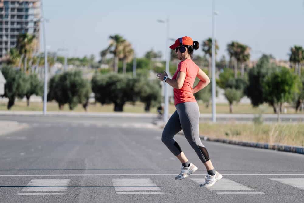 Woman crossing the street while running