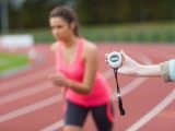 Hand timing a woman's run on the running track