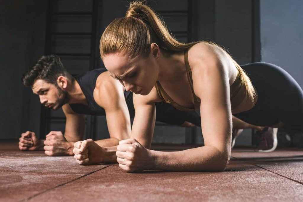 Will Running Give You Abs:male & female doing plank