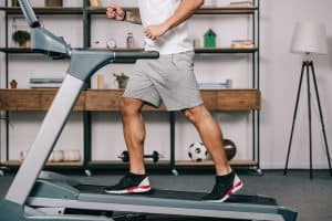 man running on treadmill indoors