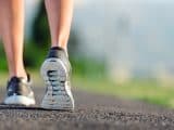 feet of an athlete running on a park pathway training for fitness and healthy lifestyle