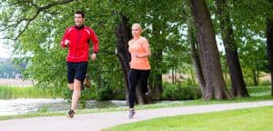 How Many Calories Does a 30 Minute Jog Burn: Woman and man jogging on dirt path 