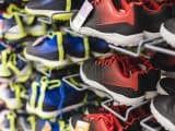Shoes of varying colors, sizes and designs on display in a sport store.