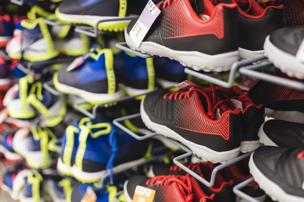 Shoes of varying colors, sizes and designs on display in a sport store.