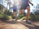 Fit marathon couple trail running together for sport and healthy living