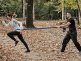Female sprinter in hard training with resistance band