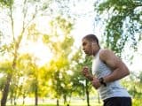 Man running in the woods with earphones