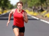 Running sport man. Fit muscular young male runner sprinting at great speed outdoors on road.