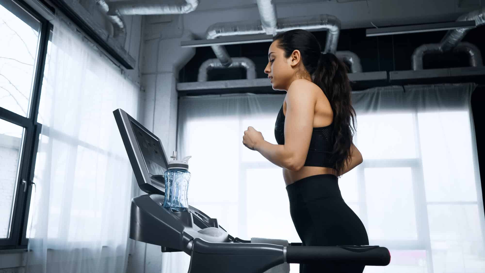 How Many Calories Do You Burn Running a Mile on a Treadmill: Woman Running on a treadmill