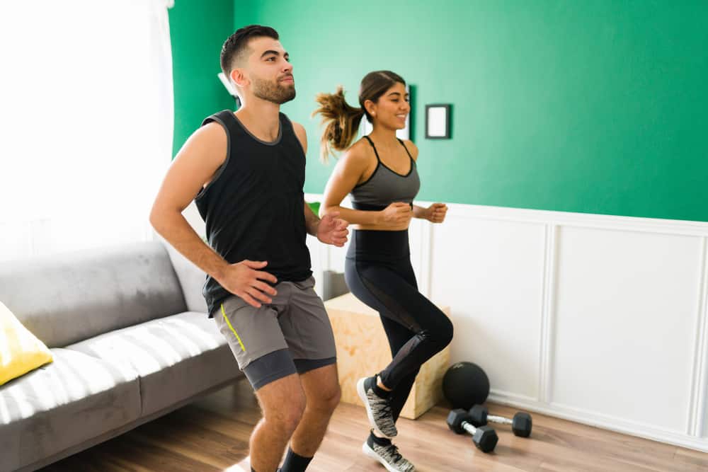 How Many Calories Does Running in Place Burn:High intensity interval training. Fitness workout partners running in place while doing a cardio workout