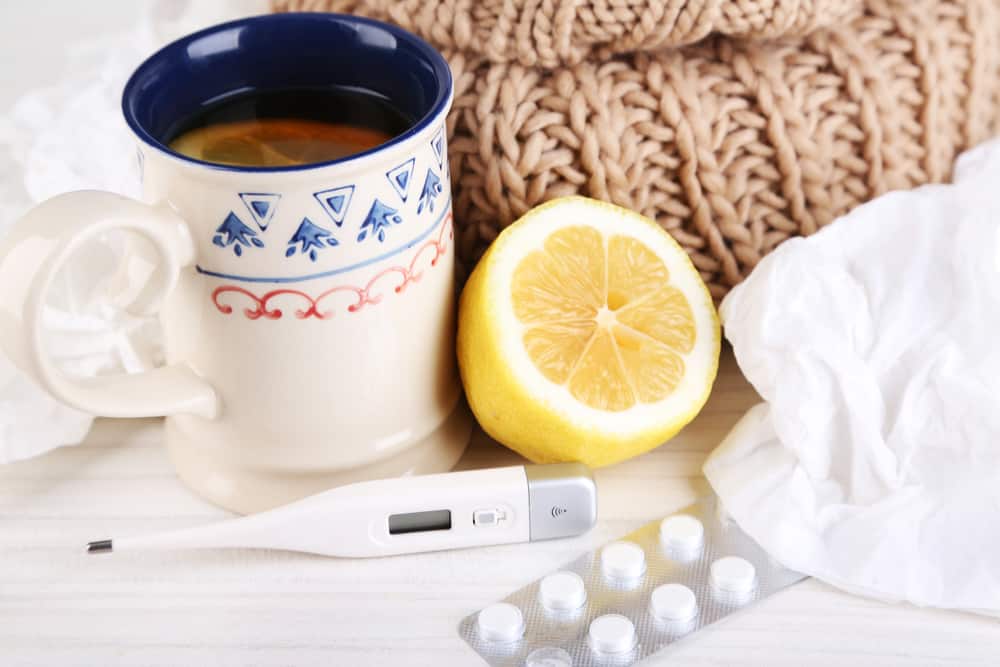 runners flu: Hot tea for colds, pills and handkerchiefs on table close-up