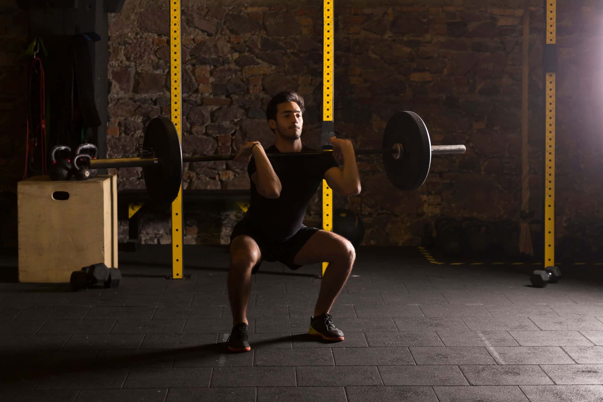 When Should I Stop Lifting Before a Half Marathon: Man lifting barbell in the gym